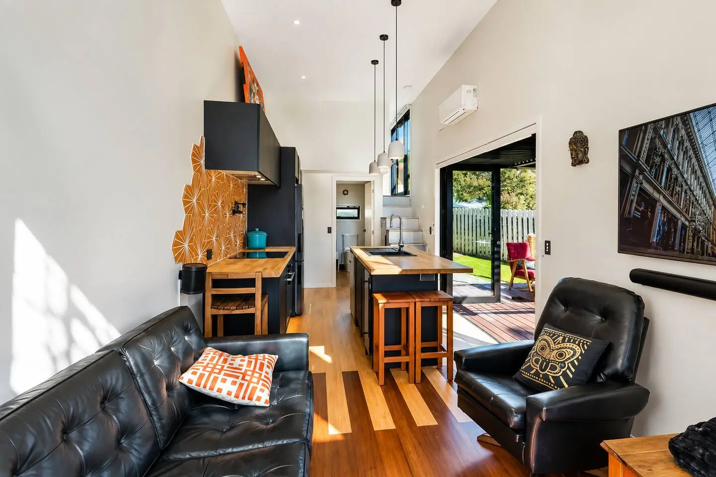 Living room and kitchen area with indoor-outdoor flow to a private deck
